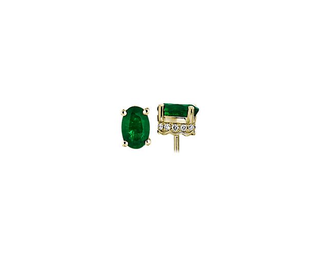 Two vibrant emerald gemstones are set in 14k yellow gold accented with pavé diamonds. The perfect set of earrings for any ensemble.