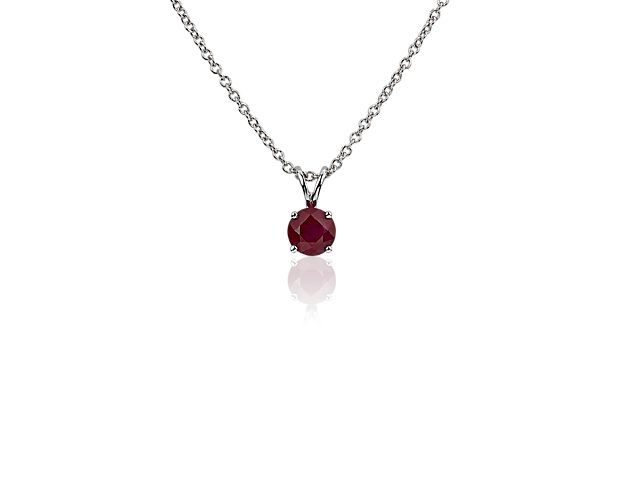 A forever classic, this ruby solitaire pendant is a perfect gift for an occasion and also makes the perfect July birthstone gift. A petite, deep ruby is framed in 18k white gold and suspended from a timeless, matching cable chain.