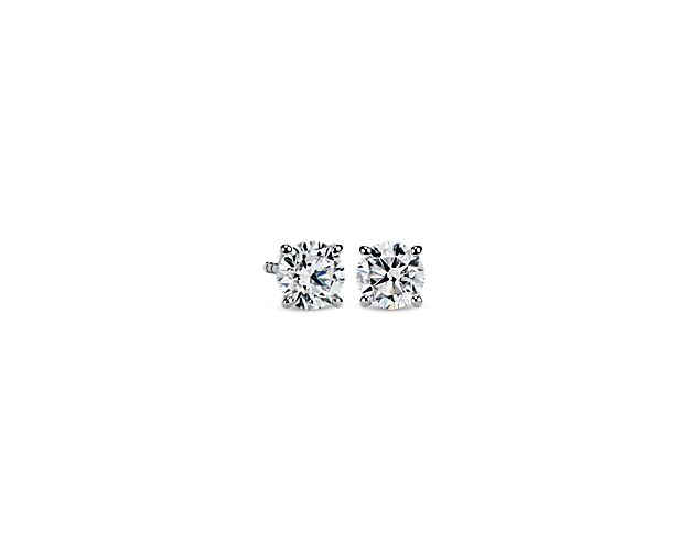 Brilliant diamonds make the light dance across these timeless stud earrings crafted from gleaming white gold.