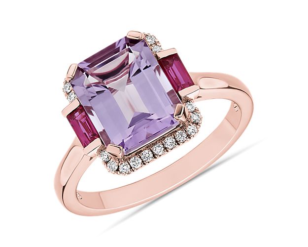 The delicate lavender tone of a Rose de France amethyst takes center stage on this effervescent ring designed with warm 14k rose gold. Two emerald cut rubies sit on either side, adding deep brilliance to the twenty two pavé diamonds bordering the amethyst’s octagonal shape.