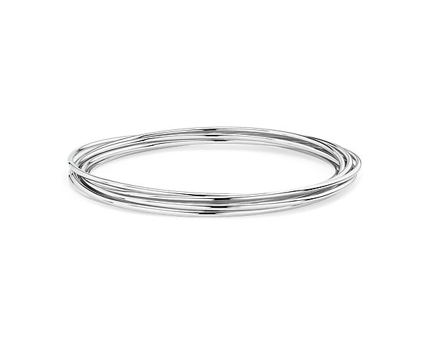 Simply chic, this set of six individual, polished bangles glide together, separating and overlapping with silky movements. Forged of sterling silver, this is the perfect everyday accessory.