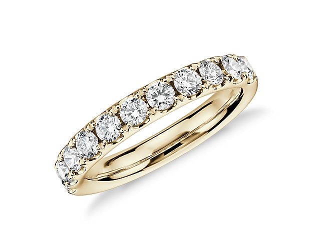 A pavé-set row of sparkling round brilliant diamonds shimmer brightly in this 18k yellow gold ring she'll treasure as a wedding or anniversary band.
