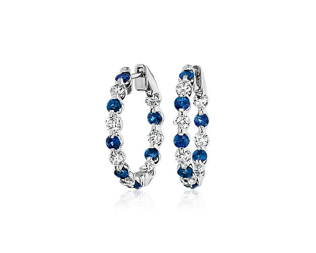 Elevate your look with 14k white gold hoop earrings adorned with floating sapphires and diamonds that alternate to create a mesmerizing design.