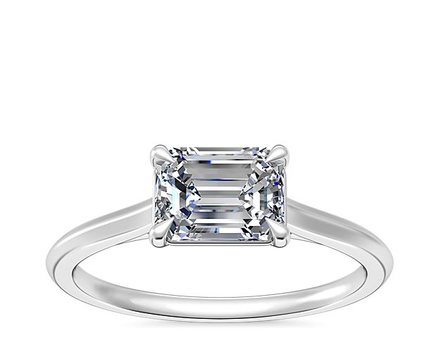 The timeless solitaire setting is updated by an east-west facing diamond in your choice of emerald, pear, marquise, or oval-cut. The solo stone set into a platinum band for maximum shine.