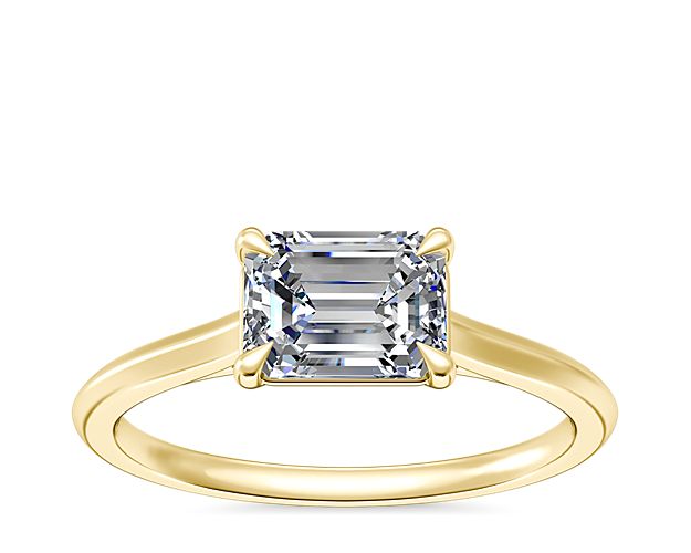The solitaire setting is a favorite for those who prefer clean lines and impeccable designs. This 14k yellow gold band offers a warm tone to contrast against the diamond of your choice, including emerald, pear, marquise, or oval-cut stones.