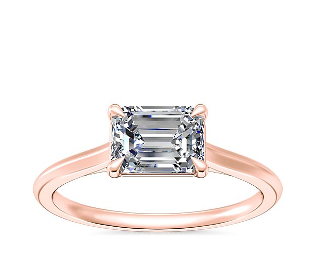 A decadent diamond takes center stage on this solitaire ring crafted with polished 14k rose gold. The timeless design supports your choice of emerald, pear, marquise, or oval-cut diamond.