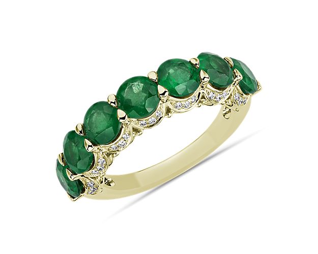 Traditionally loved emeralds sit in a row atop this 14k yellow gold ring. To make the piece a true stunner, a hidden diamond halo adds sparkle from every angle.