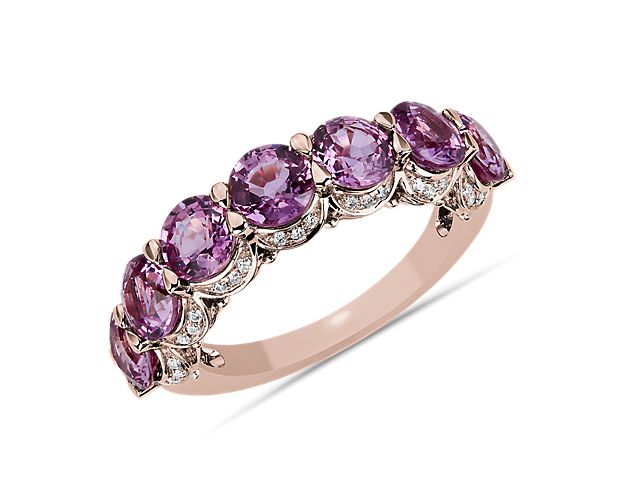 A pop of pinks adds a of flash of color to this seven-stone pink sapphire ring. A hidden diamond halo sits seamlessly in the 14k white gold band beneath the pink gems.