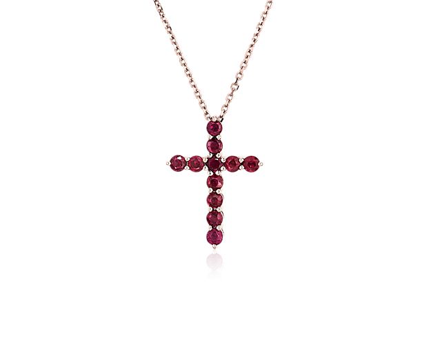 Gorgeously rich red rubies shimmer from this cross-shaped pendant, making it a beautiful symbol of faith. The warm tones of the 14k rose gold setting softly complement the colors of the rubies.