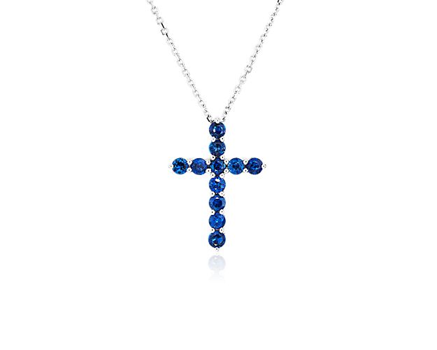 Inspire uplifting faith wherever you wear this cross pendant featuring beautifully blue sapphires shimmering along its arms. The simple and elegant 14k white gold design holds the stones in luxurious style.