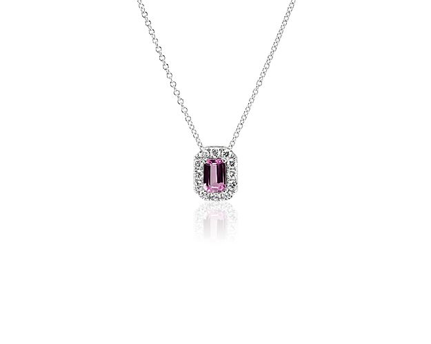 An emerald-cut pink sapphire surrounded by a diamond halo makes a sweet addition to any jewelry collection.