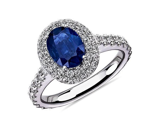 Classic in every way, this elegant sapphire gemstone ring is surrounded by a double halo of pavé-set diamonds framed in 14k white gold.