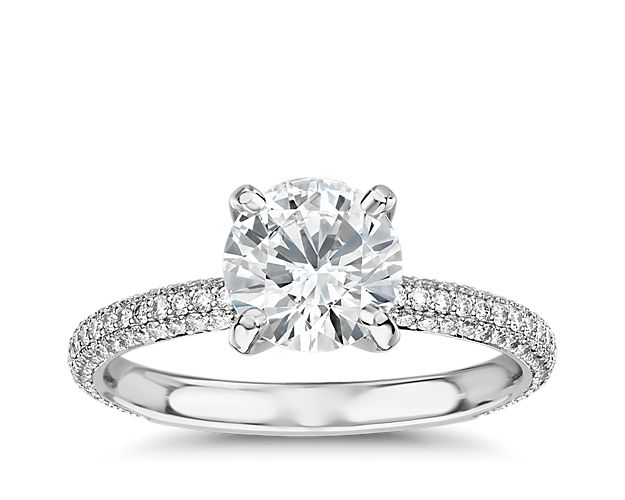 Featuring spectacular sparkle, this platinum engagement ring shines with any center stone and pavé-set diamonds rolling across the shank of the ring. With an open profile to allow for maximum light performance for any center stone of your choice.