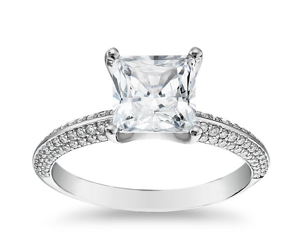 A sensational design that absolutely dazzles, this premium platinum engagement ring displays a diamond center stone with a knife-edge band exhibiting remarkable sparkle from the rows of micro pavé diamonds set along the band and prong setting.