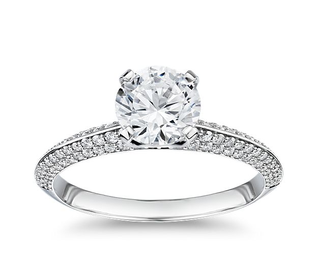 A sensational design that absolutely dazzles, this premium platinum engagement ring displays a diamond center stone with a knife-edge band exhibiting remarkable sparkle from the rows of micro pavé diamonds set along the band and prong setting.