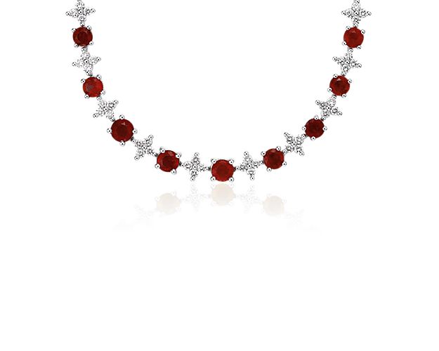 Let the sparkle live on with sophistication and bright, crimson color. This sophisticated eternity necklace features diamonds arranged in floral patterns that alternate between ruby gemstones, all set in 18k white gold. Fasten yours securely with a box clasp and safety closure.