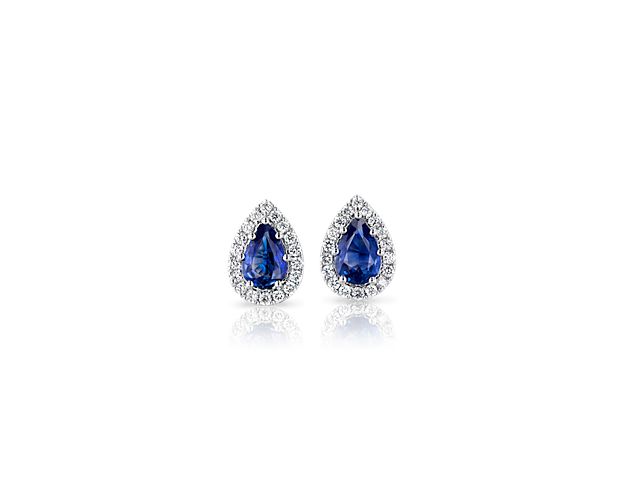 Sparkle with diamond brilliance and bold blue with a pair of these classically beautiful stud earrings. Two pear-cut sapphires dazzle from within halos of diamond pavé and shine with pure and natural glamour.