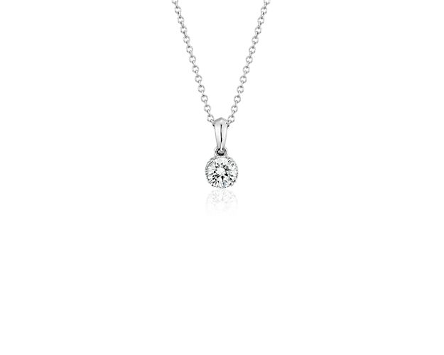 Accompanied by a certificate of authenticity guaranteeing Canadian-mined origin, this sparkling diamond pendant features a round-brilliant diamond framed in elegant 18k white gold with a matching cable chain. The necklace features a unique maple-leaf detail in the basket and an adjustable chain that may be worn at 16 or 18 inches in length.