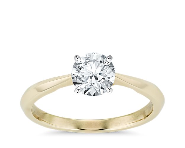 Classic and elegant, this 14k yellow gold solitaire engagement ring features a clean knife-edge shank infused with luxurious ZAC Zac Posen style with a signature 14k yellow gold interior accent.