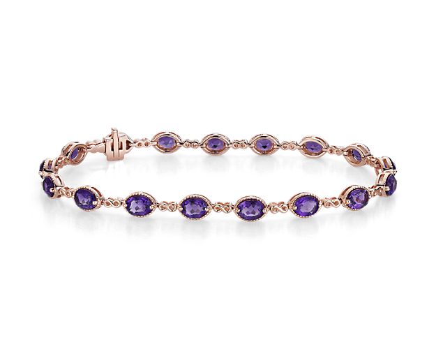 Symbolic and vibrant, this beautiful bracelet features prong-set oval amethyst gemstones connected by delicate 14k rose gold infinity links.