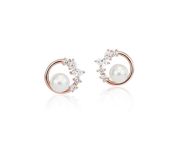 Set in the warmth of 14k rose gold, these earrings shimmer with the brilliant pairing of a freshwater pearl and a collection of round, pear and marquise-cut diamonds.