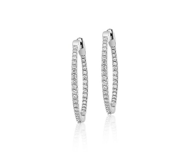Classic and brilliant, these diamond hoop earrings feature a 70 stones totaling a carat of diamonds pavé-set throughout the earrings and set in 14k white gold.