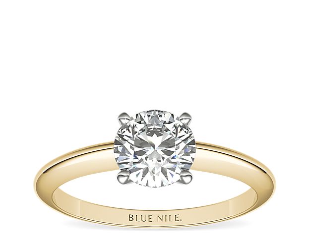 Let your diamond shine brilliantly in this classic 18k yellow gold four-prong solitaire engagement ring with  platinum prongs. The slim silhouette and polished finish exemplify timeless style. Select from a variety of diamond shapes to create the perfect classic solitaire engagement ring for you.