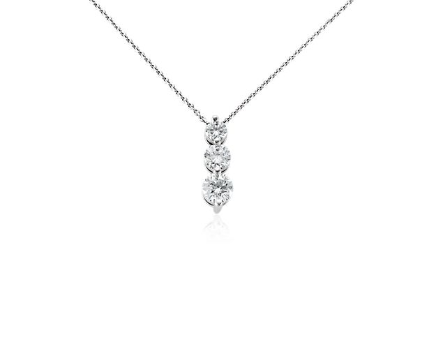 This three-stone diamond drop pendant symbolizes your past, present, and future with brilliance. Crafted in polished 18k white gold, three graduated-size diamonds cascade in shared prongs that allow for maximum sparkle. The pendant hangs from a matching classic cable chain with a secure lobster claw clasp.