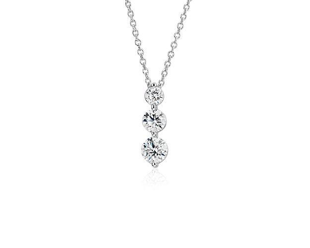 Inspired by your past, present, and future, the three-stone diamond drop pendant is a beautiful symbol that shines in polished 18k white gold. Three graduated-size round brilliant cut diamonds are set in shared prongs that maximize brilliance. The three-stone drop hangs from a classic matching cable chain with secure lobster claw clasp.