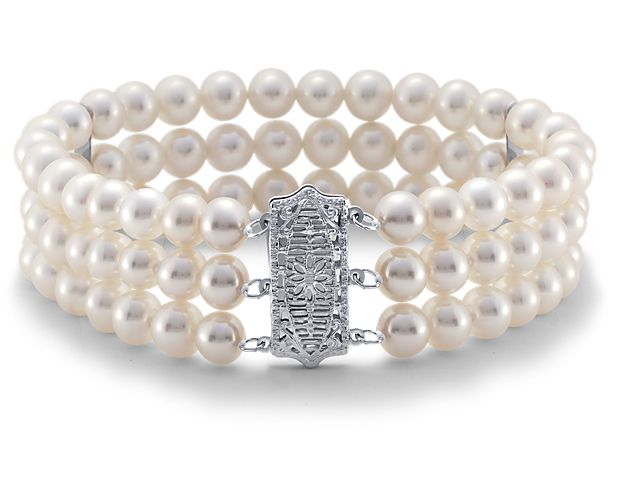 Three strands of luminescent freshwater cultured pearls are strung in parallel and perfectly accented by an elegant 14k white gold filigree clasp. Delicate 14k white gold spacers keep the strands secure and laying flat against the wrist. This pearl bracelet is a perfectly elegant bridal look.