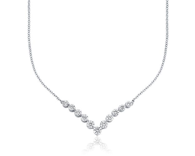 A forever favorite, this diamond "V" necklace is expertly crafted in bright 18k white gold. Near-colorless round brilliant-cut diamonds in graduated sizes are set in minimal shared prongs that allow for maximum brilliance. Hanging stationary from a matching 18k white gold cable chain, the chevron shape is both classic and a nod to modern geometric styling that perfectly accents any neckline.