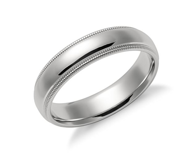This platinum wedding ring is a favorite style that is both simple and elegant. Crafted in enduring platinum with a polished finish, the slightly domed center band is framed by detailed milgrain edges. Rounded inner edges create a comfortable everyday wear.