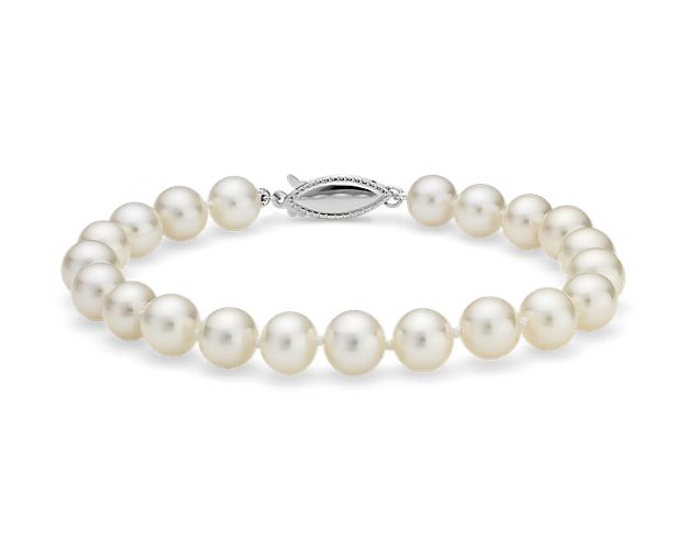 Classically luminous, this Freshwater cultured pearl bracelet features nearly-round white pearls strung on a 7.5" hand-knotted silk blend cord. A polished 14k white gold safety clasp secures the look.