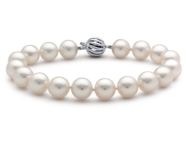 This rare South Sea cultured pearl strand bracelet features exceptionally smooth, lustrous pearls, hand-selected and beautifully matched. Their silvery white color and notable size make them a standout classic. A fluted 18k white gold ball clasp finishes it off with style and security.