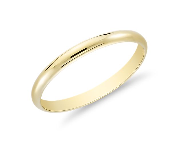 This classic 18k yellow gold wedding ring will be a lifelong essential. The light overall weight of this style and its slender, low profile aesthetic make it feel "barely there" and perfect for everyday wear. The high polished finish and goes-with-anything styling are a perfect complement to any yellow gold engagement ring.