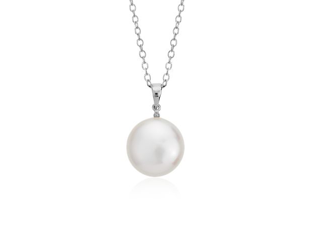 This flat coin-shaped freshwater cultured pearl is suspended from a delicate sterling silver cable chain.