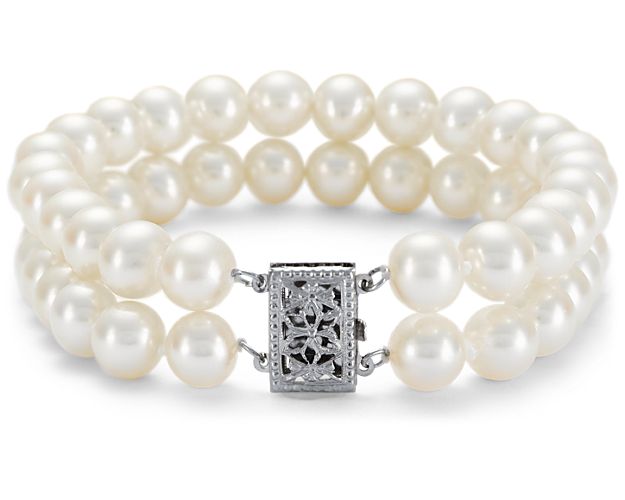 Perfect for any occasion from your wedding day to everyday, this bracelet features a double-strand of gleaming, well-matched, white Freshwater cultured pearls set in two stunning rows and finished with a 14k white gold filigree clasp.