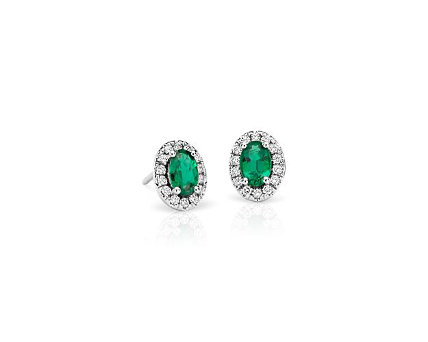 A regal halo design and majestic green hue add to the classic appeal of these emerald and pavé diamond earrings crafted of 14k white gold.