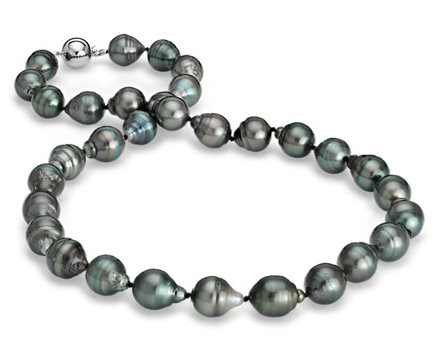 Truly one-of-a-kind, this pearl necklace features naturally black Tahitian pearls that are baroque shaped for added interest. The pearls are graduated from 10 to 11 mm and finished with a polished 18k white gold clasp.