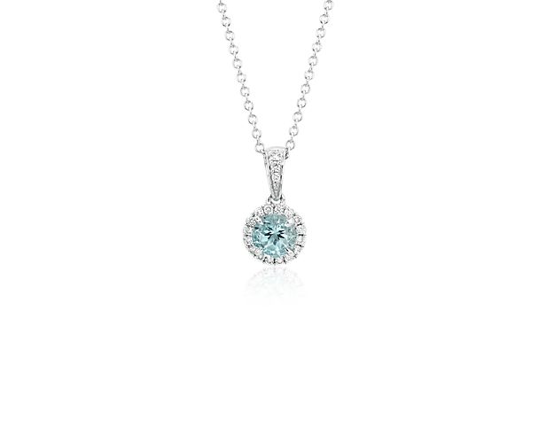 Delicate in design, this aquamarine and diamond pendant features a light blue, round aquamarine framed by micropavé-set diamonds in 18k white gold with a matching cable chain necklace.
