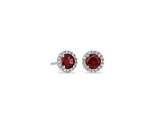 These deep red garnet and diamond halo earrings are an excellent choice for someone who wants to add a bit of color to a classic style. Crafted in bright 18k white gold, these gemstone stud earrings feature round garnets surrounded by sparkling halos of micropavé diamonds. Their petite size makes them a great everyday jewelry option.