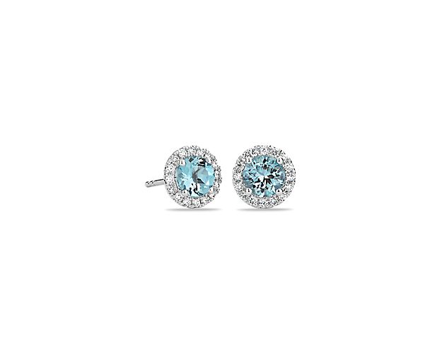These light blue aquamarine and diamond halo earrings are an excellent choice for someone who wants to add a bit of color to a classic style. Crafted in bright 18k white gold, these gemstone stud earrings feature round aquamarines surrounded by sparkling halos of micropavé diamonds. Their petite size makes them a great everyday jewelry option.