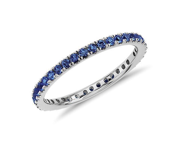 This sapphire eternity ring features a petite row of deep blue gemstones set in 18k white gold.