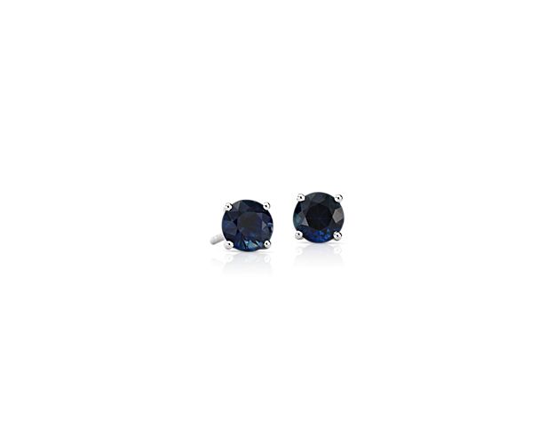 Color outside the lines with these sapphire stud earrings. A pair of perfectly matched round sapphires in a deep blue shade are set in classic 18k white gold four-prong settings perfect for adding personality to your everyday attire.