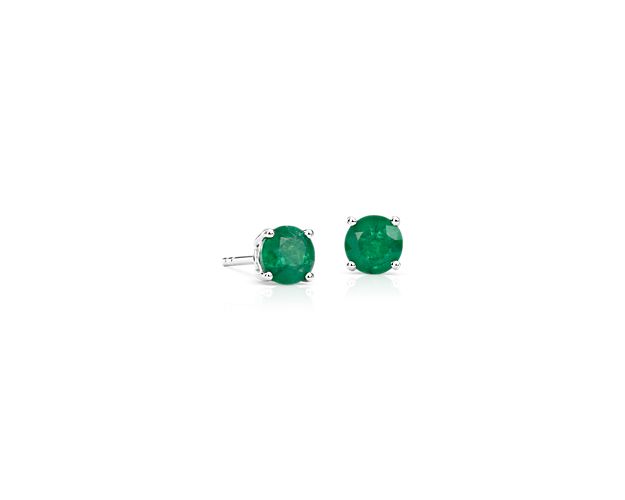 Color outside the lines with these emerald stud earrings. A pair of perfectly matched round emeralds in a lively medium green shade are set in classic 18k white gold four-prong settings perfect for adding personality to your everyday attire.