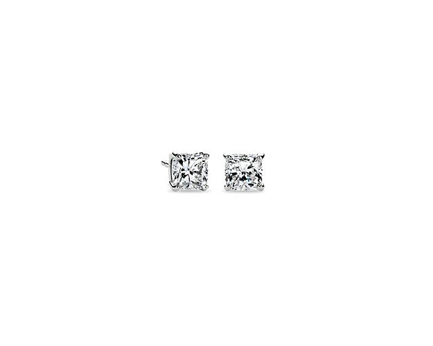 A perfectly matched pair of cushion cut diamonds are secured in 14k white gold four-prong settings with push back posts for pierced ears.