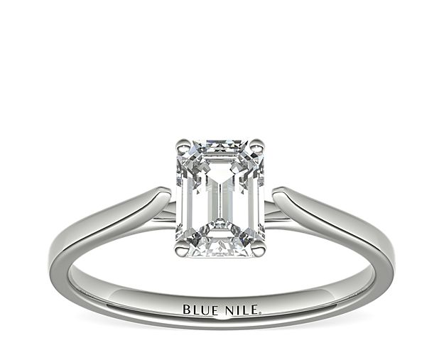 Delicate cathedral shoulders add classic elegance to this petite platinum solitaire engagement ring setting.