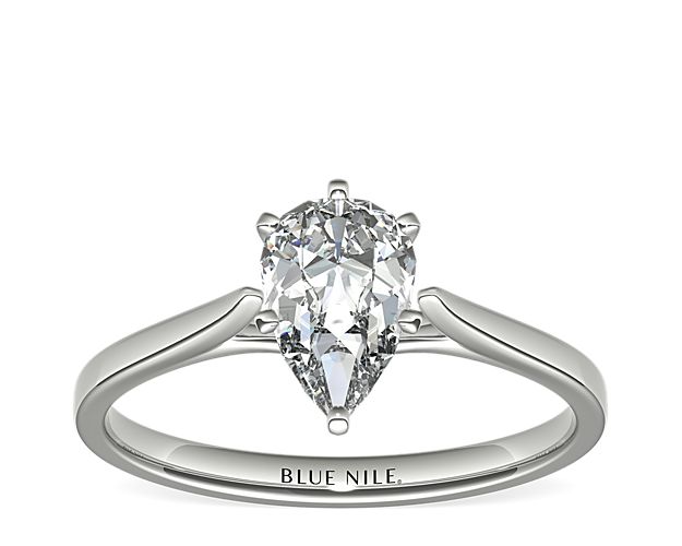 Delicate cathedral shoulders add classic elegance to this petite platinum solitaire engagement ring setting.