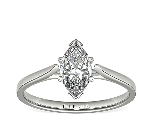 Delicate cathedral shoulders add classic elegance to this petite 14k white gold solitaire engagement ring setting.
