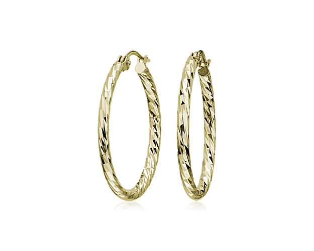 A chic earring and instant essential, our hammered hoop earrings are crafted in hollow 14k yellow gold for a lightweight, everyday look. They feature hinged closures and a gently textured finish for added interest.